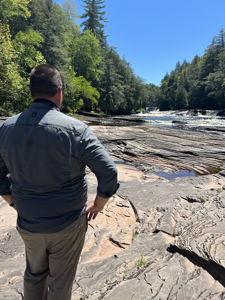 Jason standing in front of Manabezho Falls