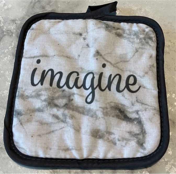 Cooking hot pad with the word “Imagine”
